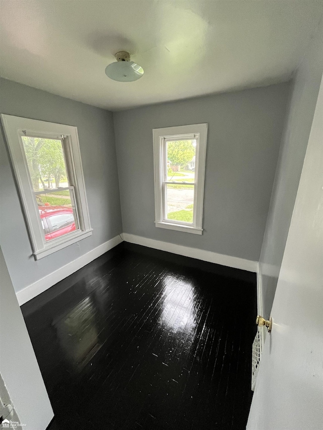 unfurnished room with hardwood / wood-style floors