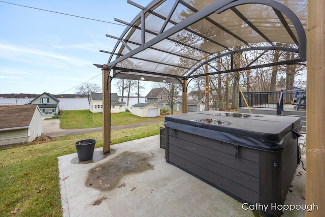 view of patio / terrace with a hot tub and a pergola