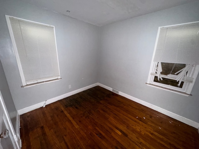 unfurnished room featuring dark hardwood / wood-style flooring