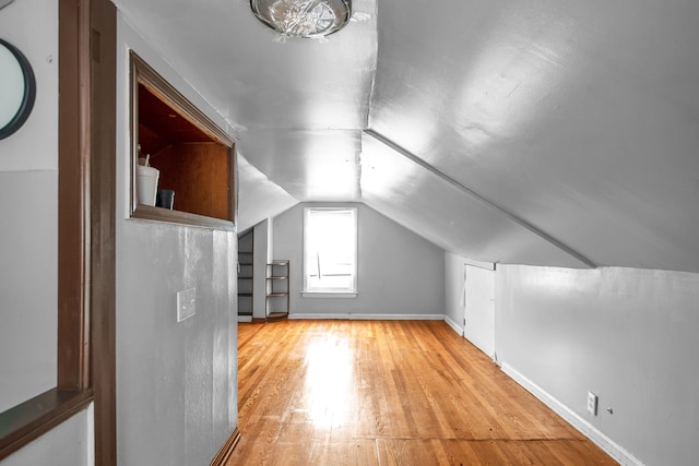 bonus room featuring vaulted ceiling and light hardwood / wood-style floors