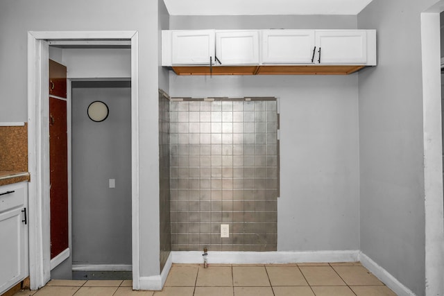 interior space featuring white cabinetry and light tile patterned flooring