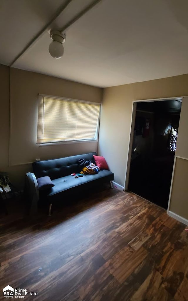 sitting room featuring dark wood-type flooring