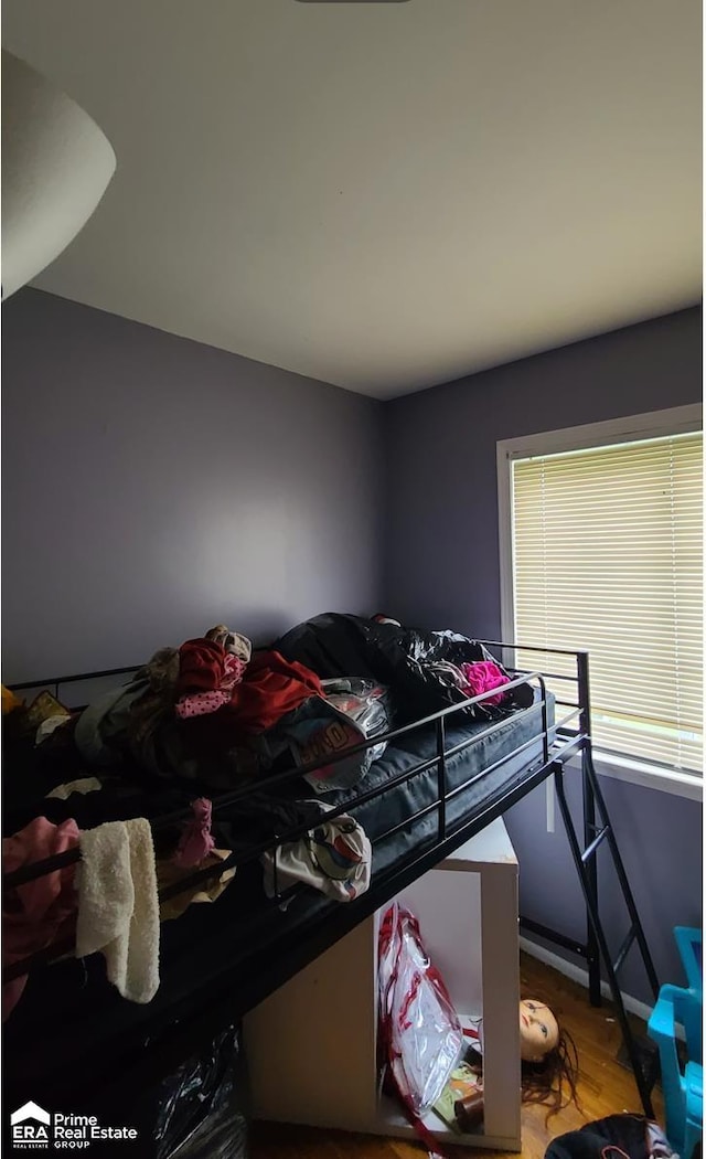 bedroom with hardwood / wood-style floors