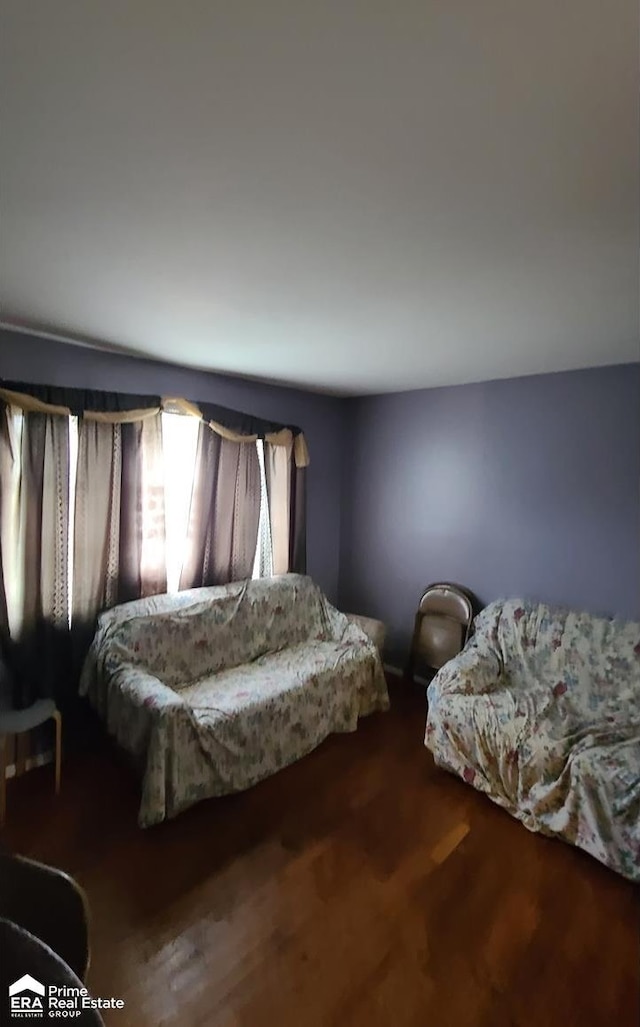 bedroom with dark hardwood / wood-style floors