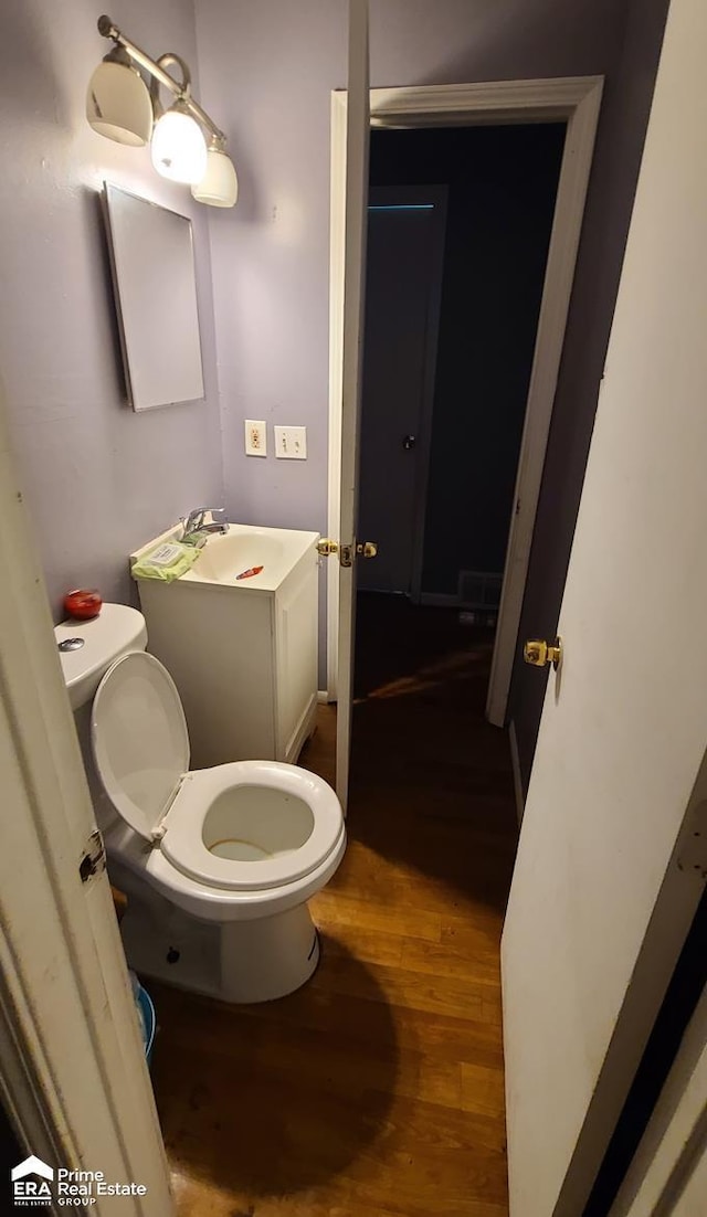 1181 Oleander Dr, Mount Morris, MI 48458 - bathroom featuring wood finished floors, toilet, and a sink