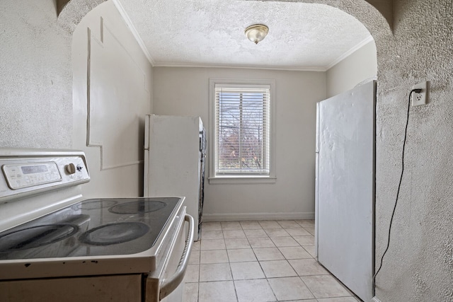 kitchen with light tile patterned floors, ornamental molding, a textured ceiling, and white electric range