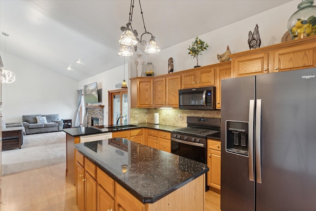 kitchen with black appliances, a center island, pendant lighting, and tasteful backsplash