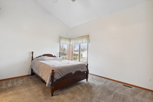 bedroom with ceiling fan, carpet floors, and high vaulted ceiling