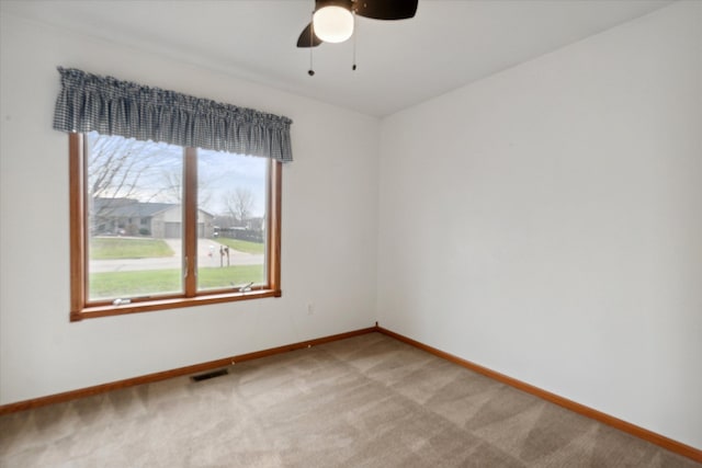 empty room with ceiling fan and carpet