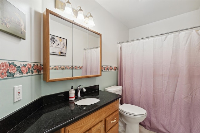 bathroom with vanity, a shower with shower curtain, and toilet