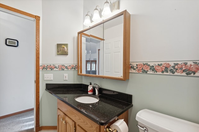 bathroom featuring vanity and toilet