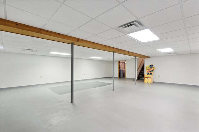 basement with a paneled ceiling