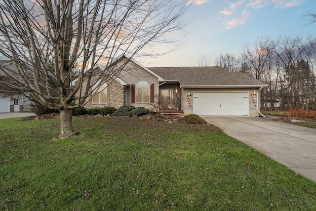 ranch-style house with a garage and a lawn