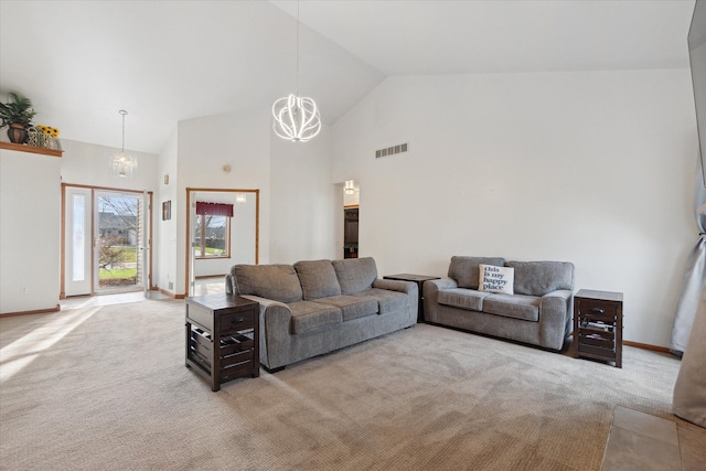 living room featuring light colored carpet, a chandelier, and high vaulted ceiling