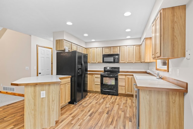 5279 Vinton Rd, Williamsburg, MI 49690 - kitchen featuring black appliances, light brown cabinets, light wood finished floors, light countertops, and recessed lighting