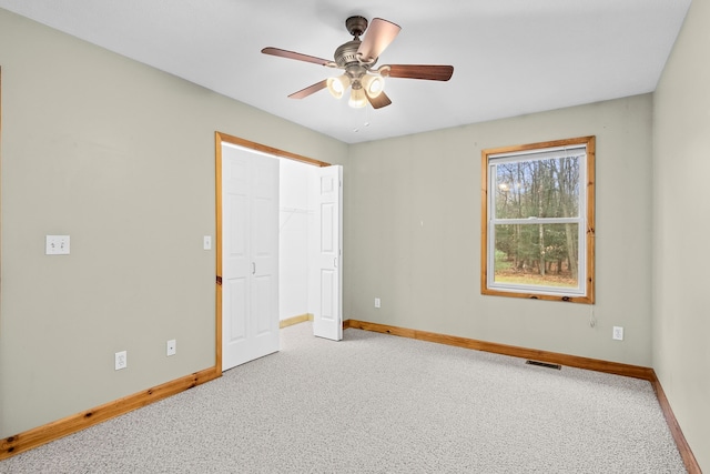 5279 Vinton Rd, Williamsburg, MI 49690 - unfurnished bedroom with carpet, baseboards, a ceiling fan, and a closet