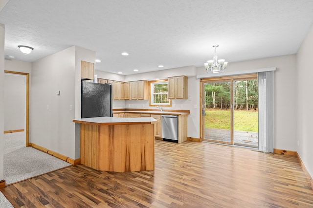 5279 Vinton Rd, Williamsburg, MI 49690 - kitchen featuring stainless steel dishwasher, freestanding refrigerator, baseboards, light wood-style floors, and a peninsula