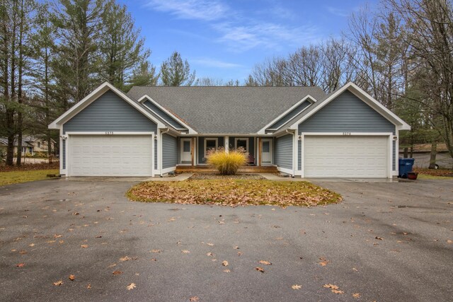 5279 Vinton Rd, Williamsburg, MI 49690 - ranch-style home with a garage, asphalt driveway, and a shingled roof