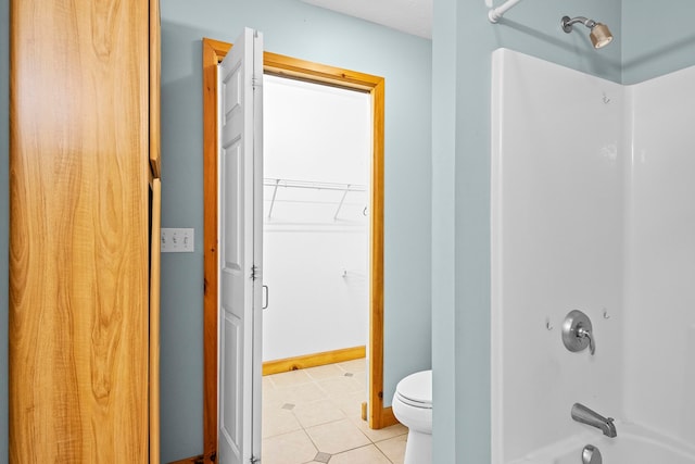 5279 Vinton Rd, Williamsburg, MI 49690 - bathroom with toilet, washtub / shower combination, tile patterned floors, and a walk in closet