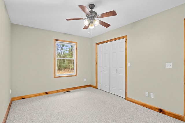 5279 Vinton Rd, Williamsburg, MI 49690 - unfurnished bedroom featuring baseboards, carpet flooring, a closet, and a ceiling fan