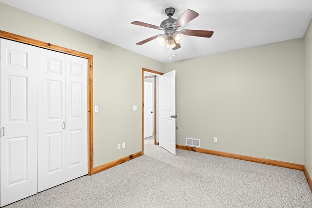 5279 Vinton Rd, Williamsburg, MI 49690 - unfurnished bedroom with baseboards, carpet flooring, a closet, and a ceiling fan