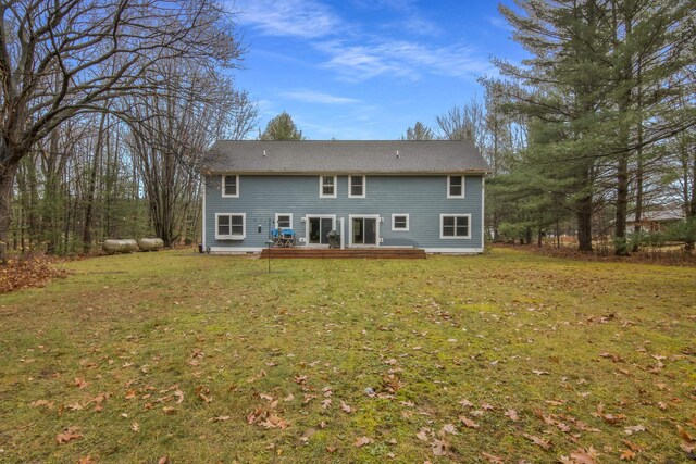 5279 Vinton Rd, Williamsburg, MI 49690 - rear view of house with a wooden deck and a yard