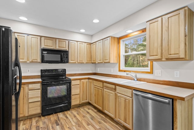 5279 Vinton Rd, Williamsburg, MI 49690 - kitchen with black appliances, a sink, light brown cabinets, light wood-style flooring, and recessed lighting