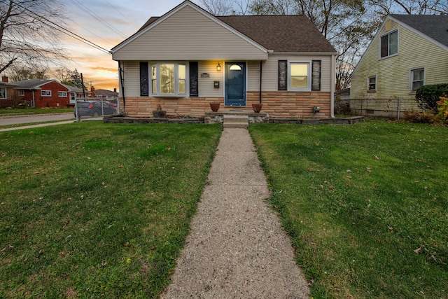 bungalow-style home with a yard