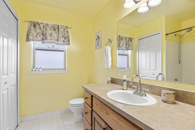 bathroom with a shower, tile patterned flooring, vanity, and toilet