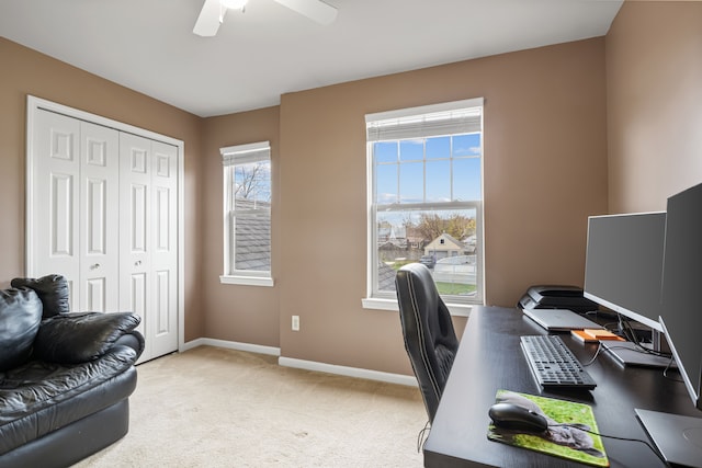 carpeted home office featuring ceiling fan and a wealth of natural light