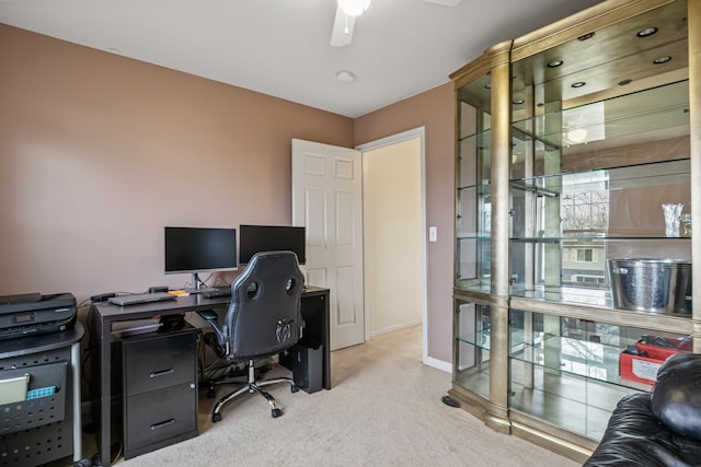 carpeted office featuring ceiling fan