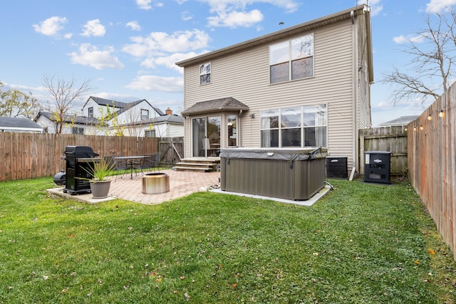 rear view of house featuring central AC, a yard, a hot tub, and a patio area