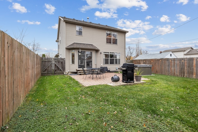 back of house with a yard and a patio