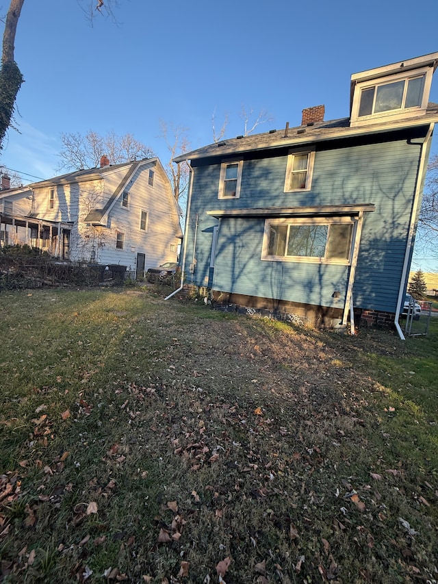 rear view of house with a lawn