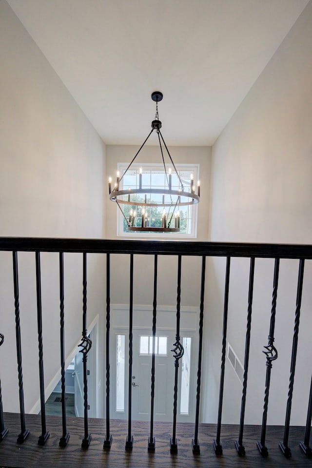 stairway featuring a chandelier