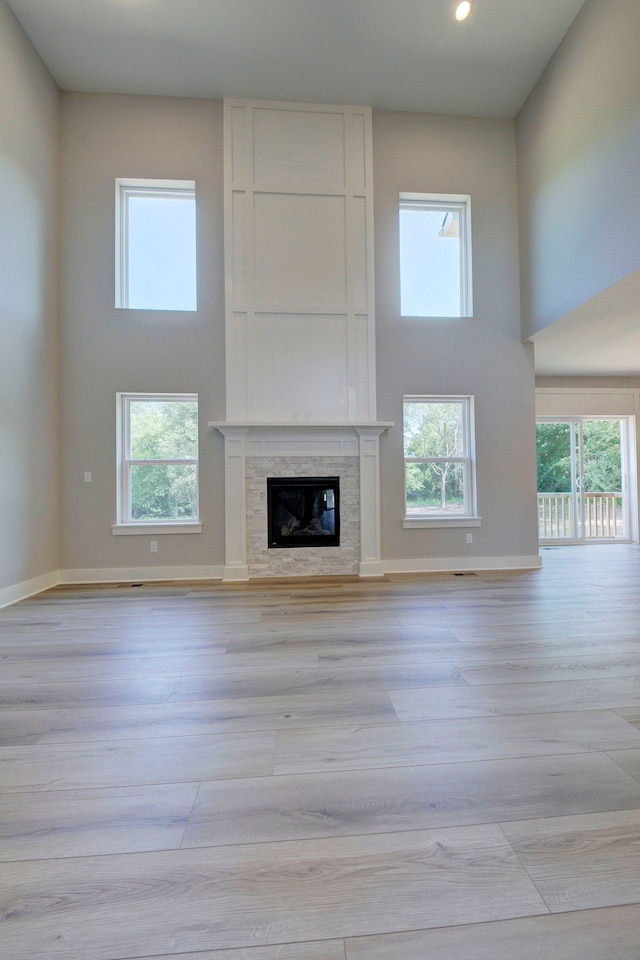 unfurnished living room with light hardwood / wood-style floors and plenty of natural light