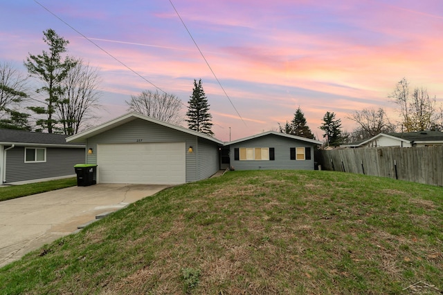 ranch-style house with a lawn and a garage