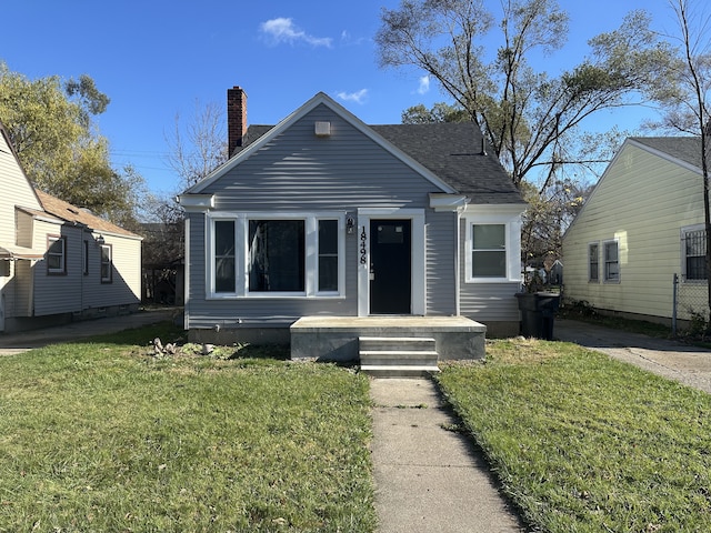 bungalow-style home featuring a front yard