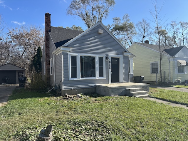 bungalow-style house featuring a front lawn