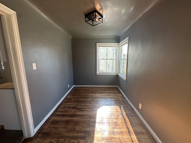 unfurnished room featuring dark wood-type flooring