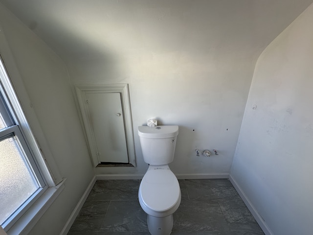 bathroom with toilet and vaulted ceiling