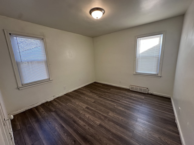 unfurnished room featuring dark hardwood / wood-style flooring