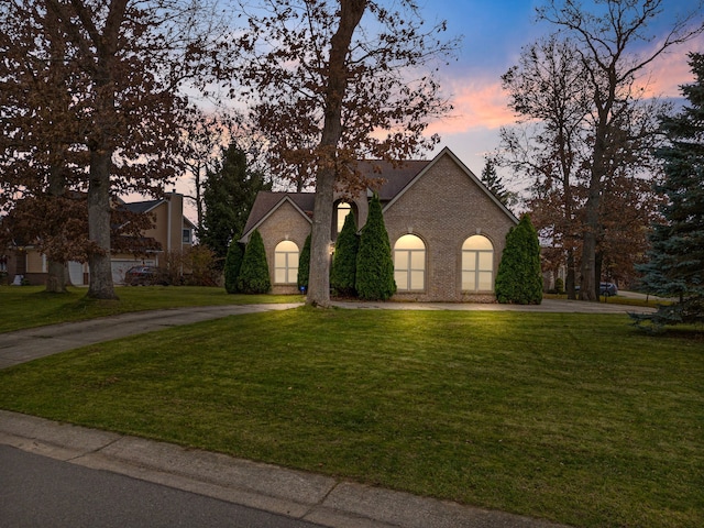 french provincial home with a lawn