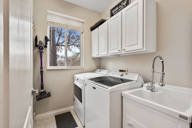 laundry area featuring light tile patterned flooring, cabinets, independent washer and dryer, and sink