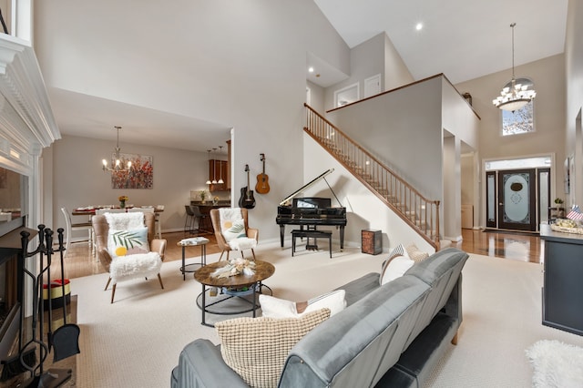 living room with light wood-type flooring, high vaulted ceiling, and a chandelier