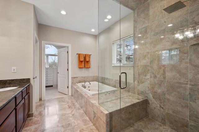 bathroom featuring plenty of natural light, vanity, and plus walk in shower