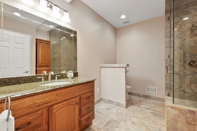 bathroom with vanity, toilet, and walk in shower