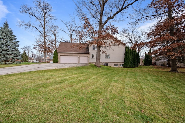 view of front of property with a garage and a front lawn