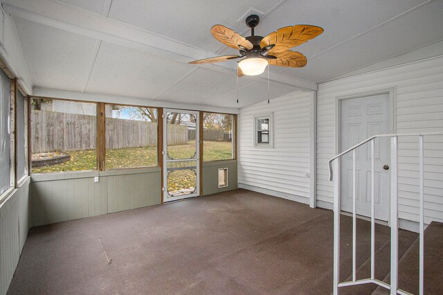 unfurnished sunroom with ceiling fan and vaulted ceiling