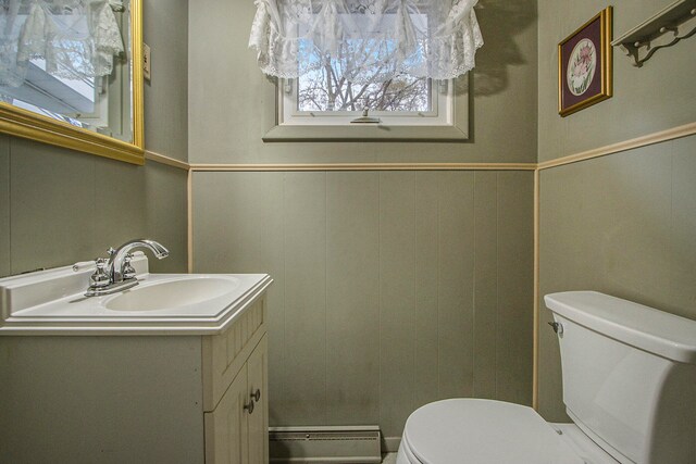 bathroom featuring vanity, a baseboard radiator, and toilet